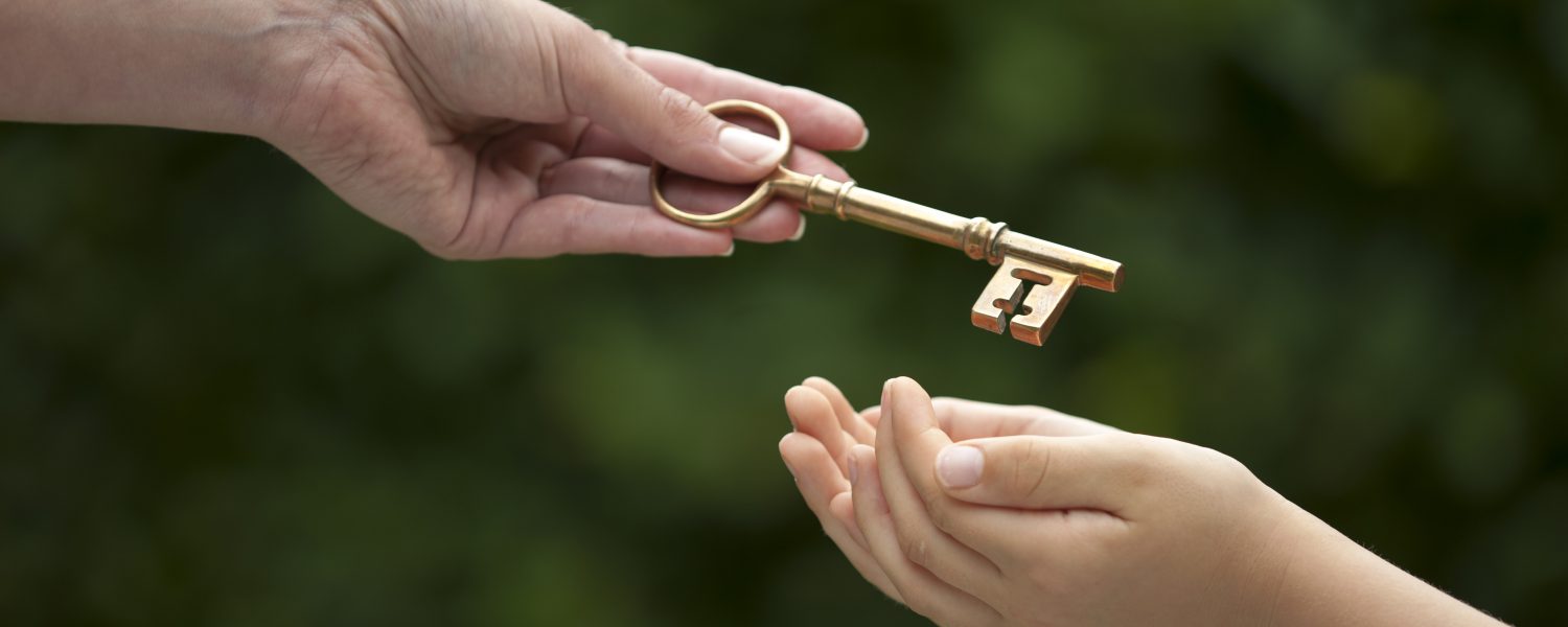 mother handing key to daughter